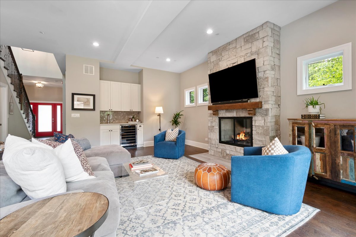 2921 Simpson Street Evanston, IL 60201 - Photo 12 of 41 a living room with furniture a flat screen tv and a fireplace