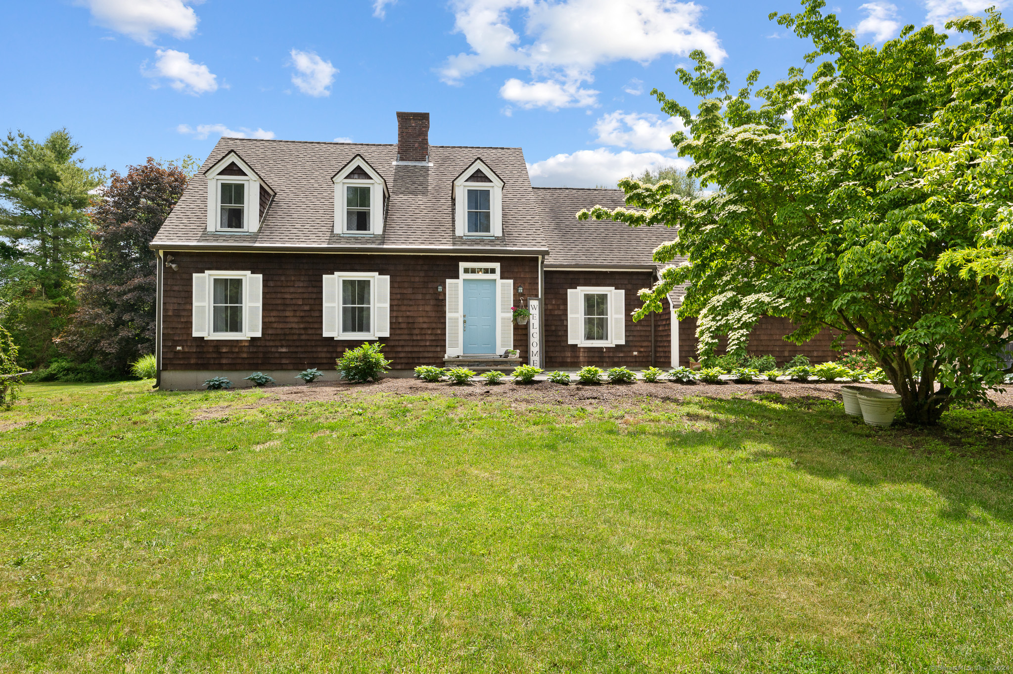 a front view of a house with a yard