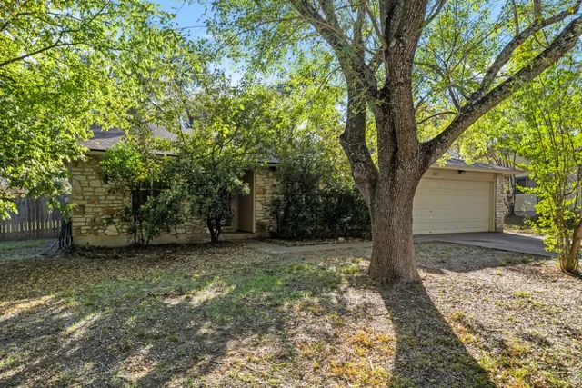 a view of a house with a tree in front of a house