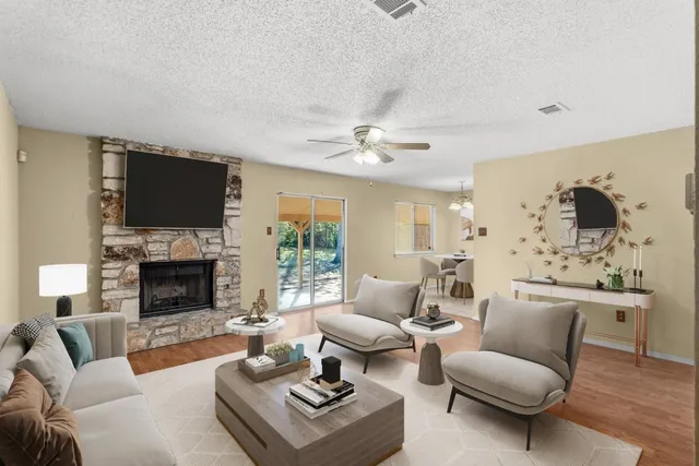 a living room with furniture a fireplace and a flat screen tv