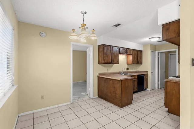 a kitchen with kitchen island granite countertop a stove oven and sink