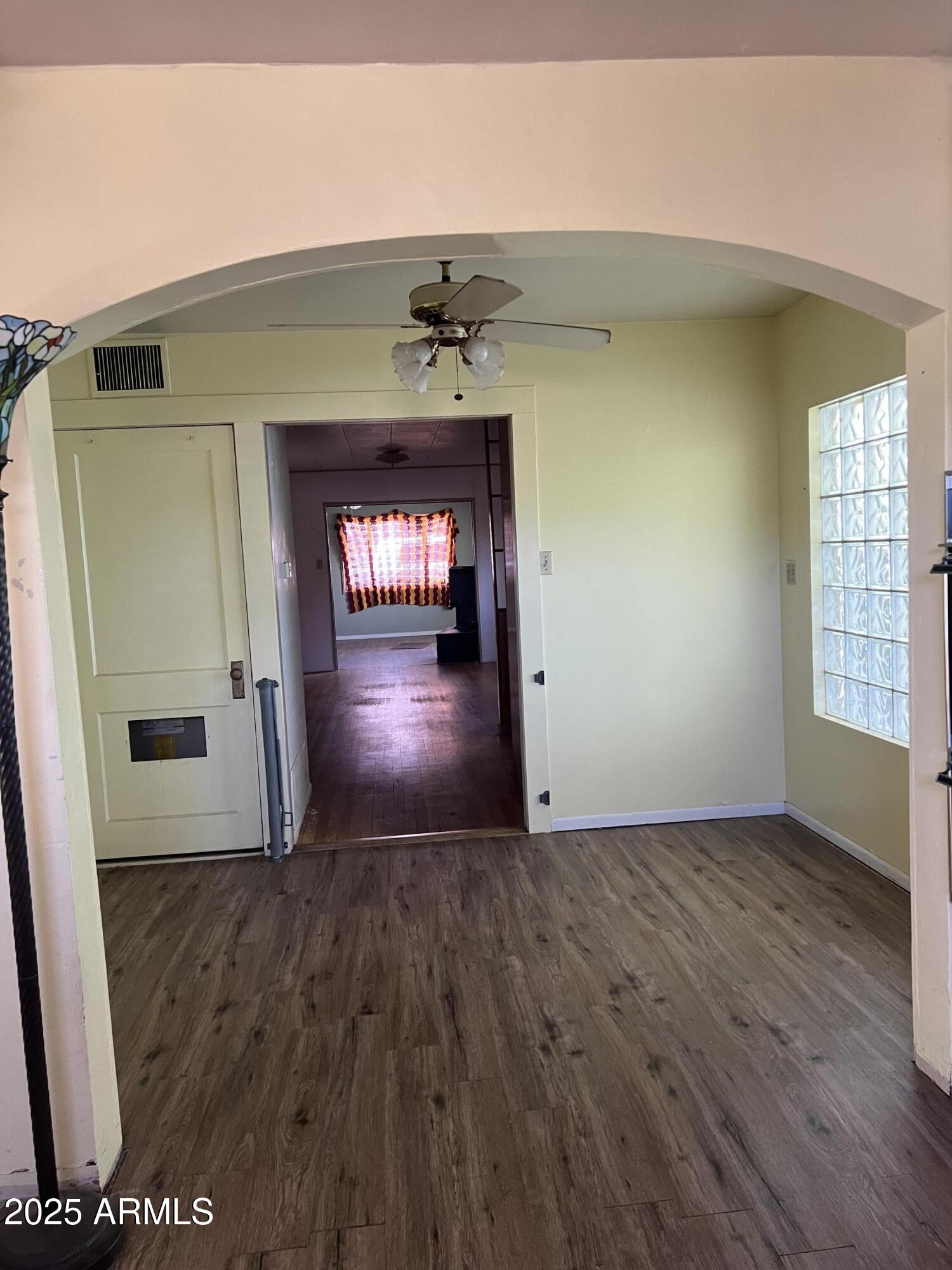 566 Carico Street Globe, AZ 85501 - Photo 10 of 22 an empty room with wooden floor and a fireplace