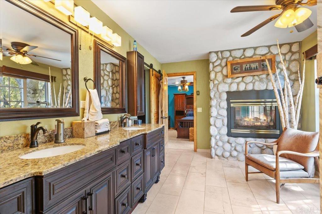 10499 Highway 79 Descanso, CA 91916 - Photo 19 of 75 a spacious bathroom with a granite countertop sink and a mirror