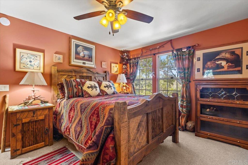 10499 Highway 79 Descanso, CA 91916 - Photo 30 of 75 a bedroom with a bed and a chandelier