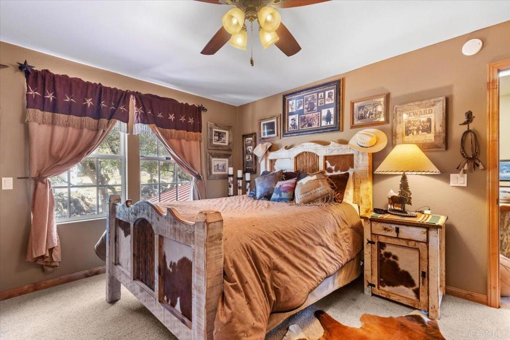 10499 Highway 79 Descanso, CA 91916 - Photo 31 of 75 a bedroom with a bed and a lamp on dresser next to a window