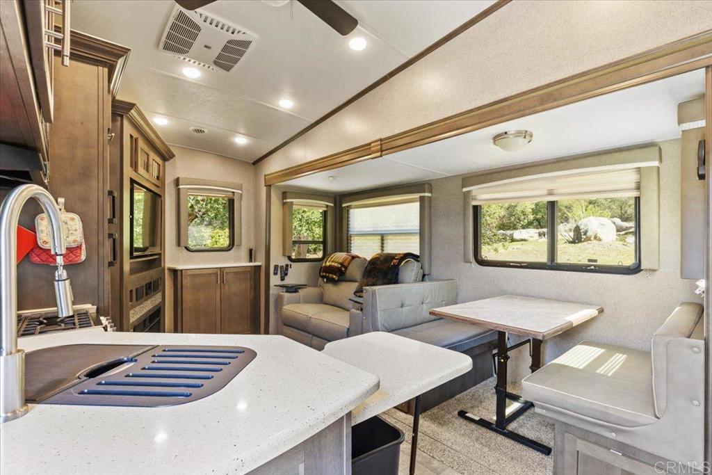 10499 Highway 79 Descanso, CA 91916 - Photo 48 of 75 a view of a dining room with furniture a chandelier and wooden floor