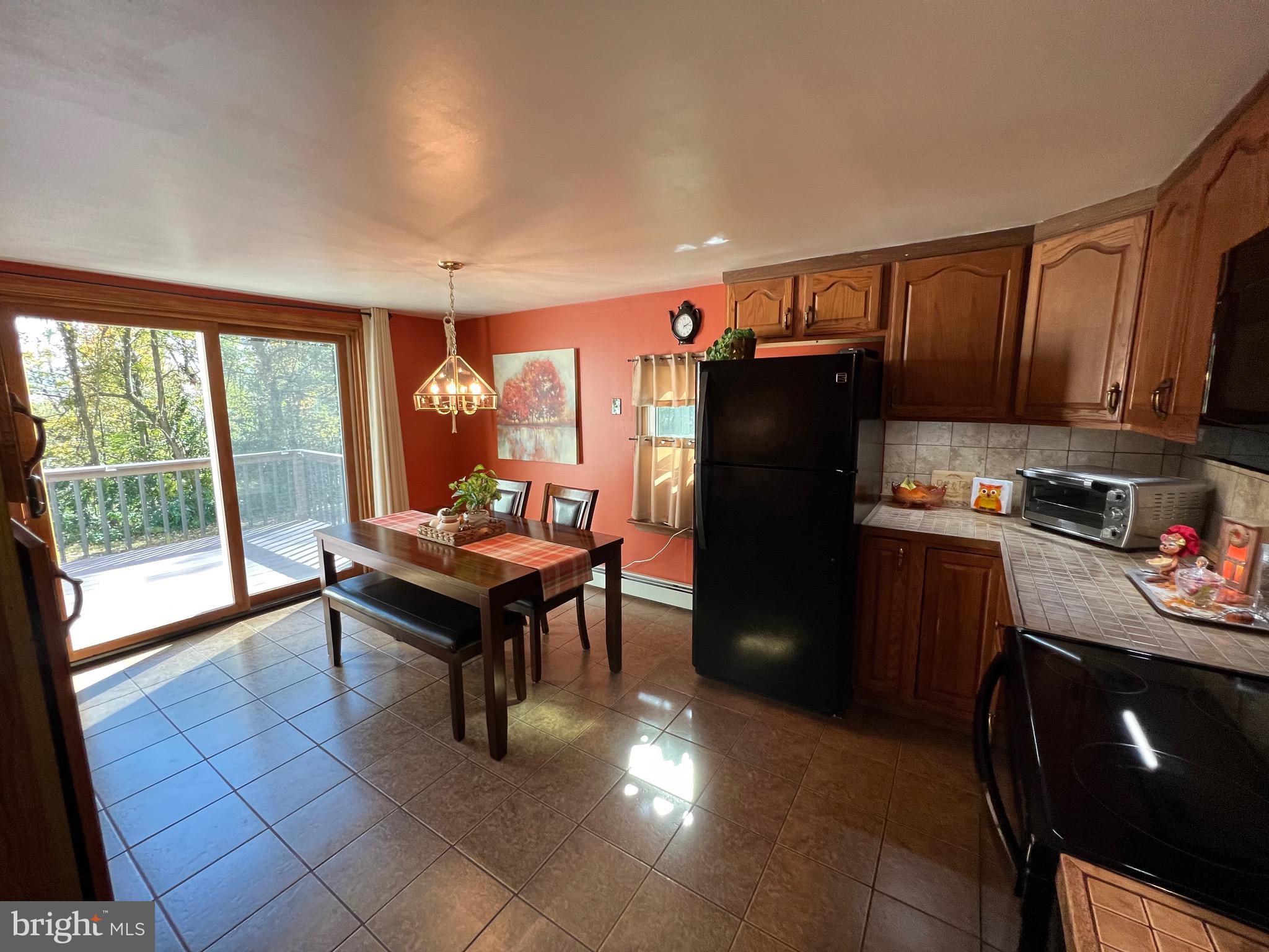 311 Lyonstown Road Bellefonte, PA 16823 - Photo 23 of 43 a kitchen with a refrigerator a stove top oven and a view of living room