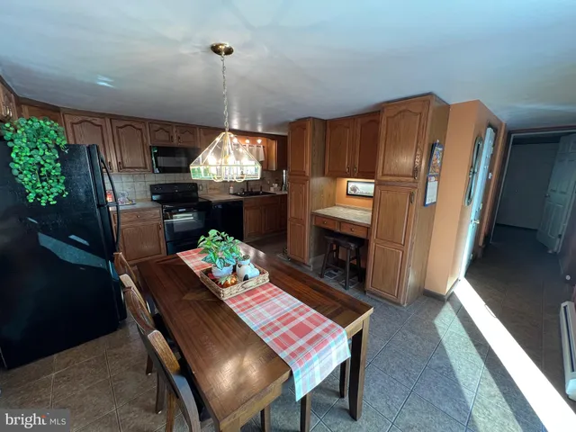 a dining room with furniture a chandelier and wooden floor