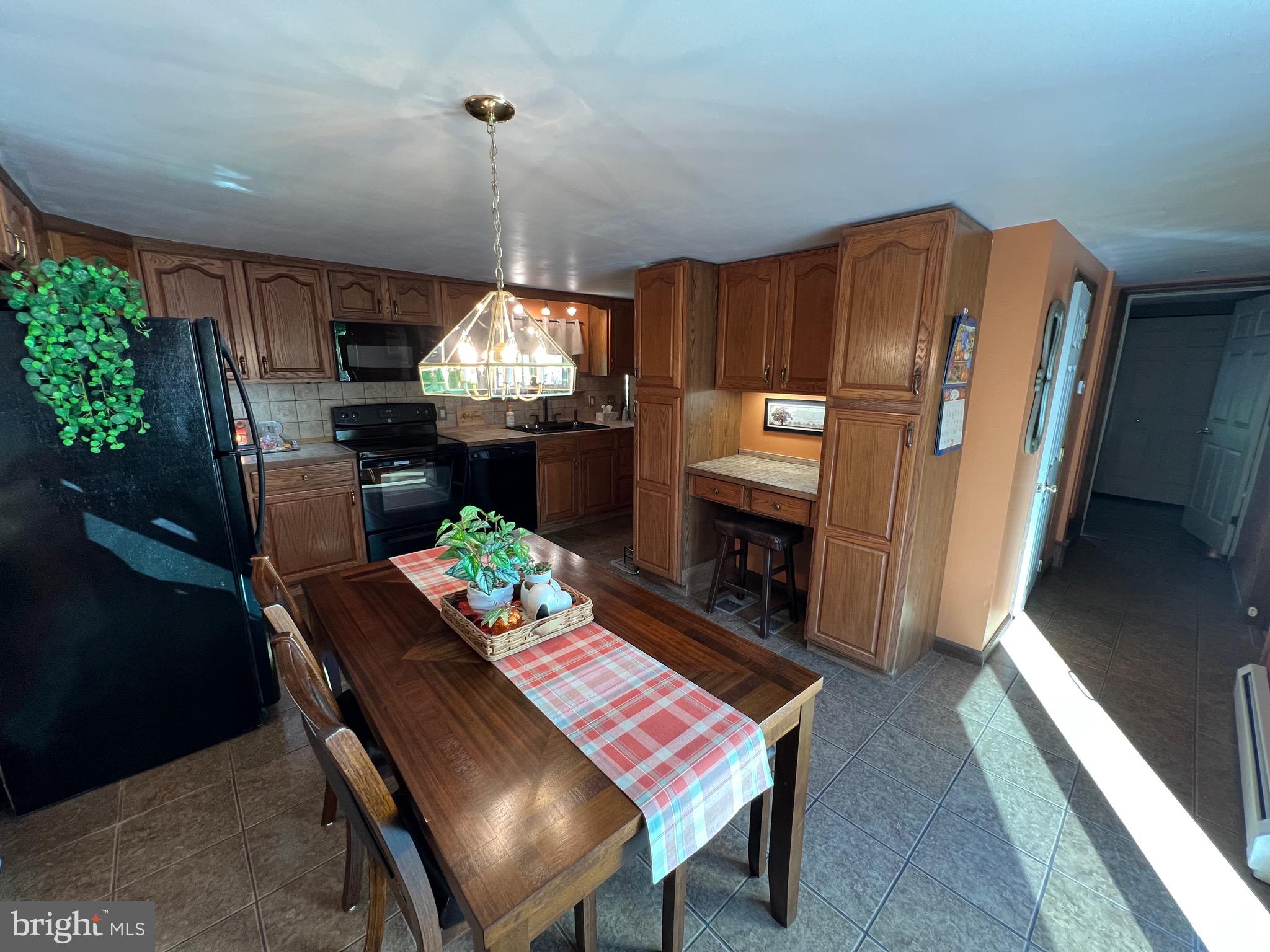 311 Lyonstown Road Bellefonte, PA 16823 - Photo 24 of 43 a dining room with furniture a chandelier and wooden floor