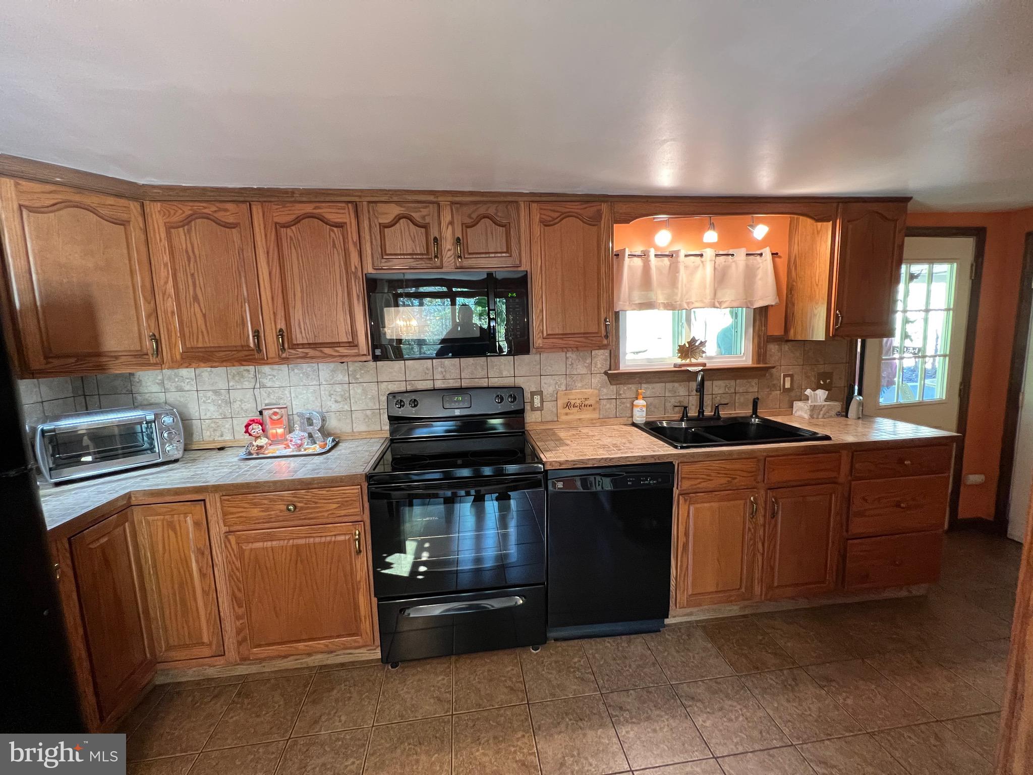 311 Lyonstown Road Bellefonte, PA 16823 - Photo 26 of 43 a kitchen with stainless steel appliances granite countertop a stove a sink and a microwave