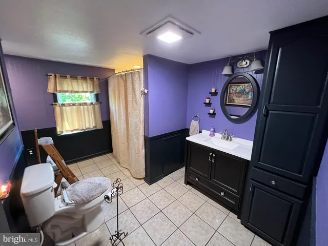 a bathroom with a sink mirror vanity and toilet