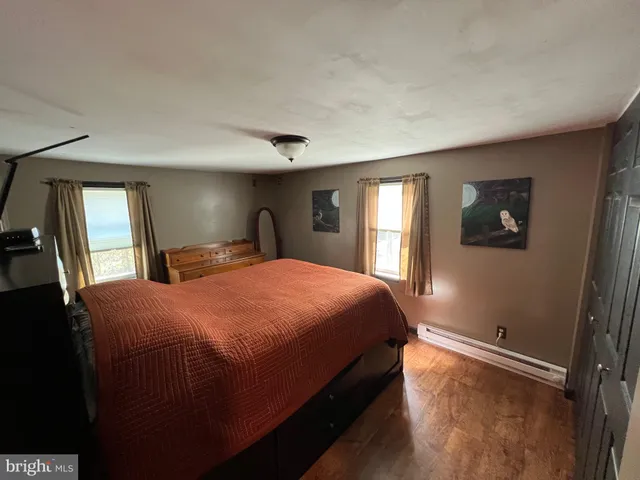 a bedroom with a large bed and a large window