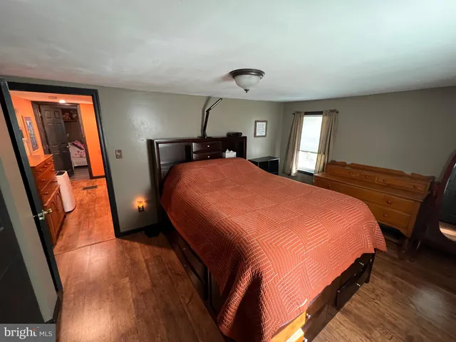 a bedroom with a bed and large windows