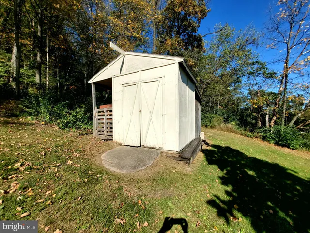 a view of backyard with tub and trees around