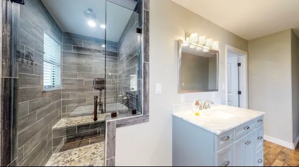 a bathroom with a sink and mirror