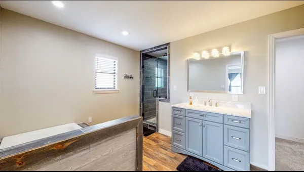 a spacious bathroom with a granite countertop sink mirror and a