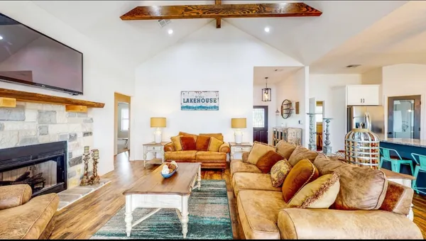 a living room with furniture fireplace and a flat screen tv