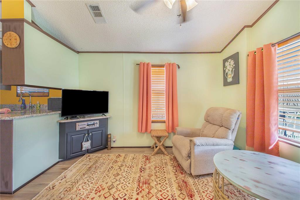 475 Pine Loop Frostproof, FL 33843 - Photo 20 of 40 a living room with furniture and a flat screen tv