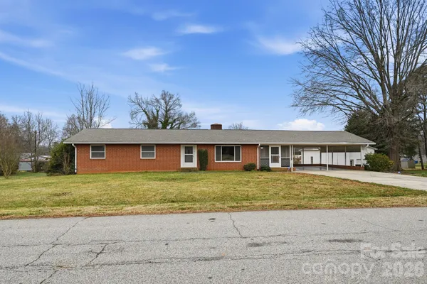 a front view of a house with a garden and yard