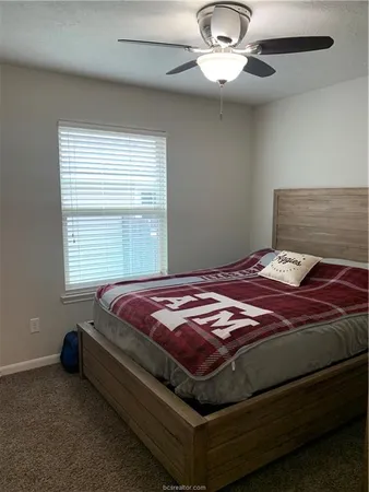 a bedroom with a bed and window