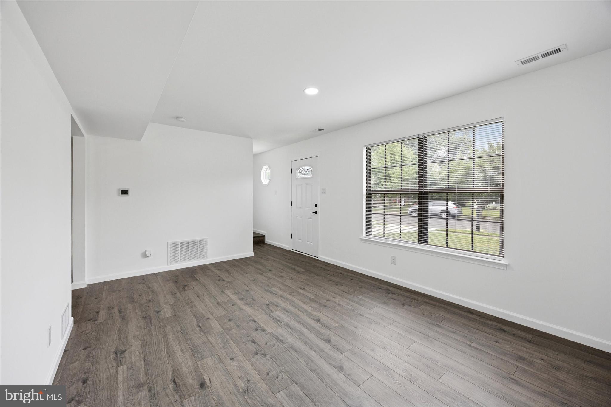 532 Cormorant Drive Voorhees, NJ 08043 - Photo 3 of 25 an empty room with wooden floor and windows