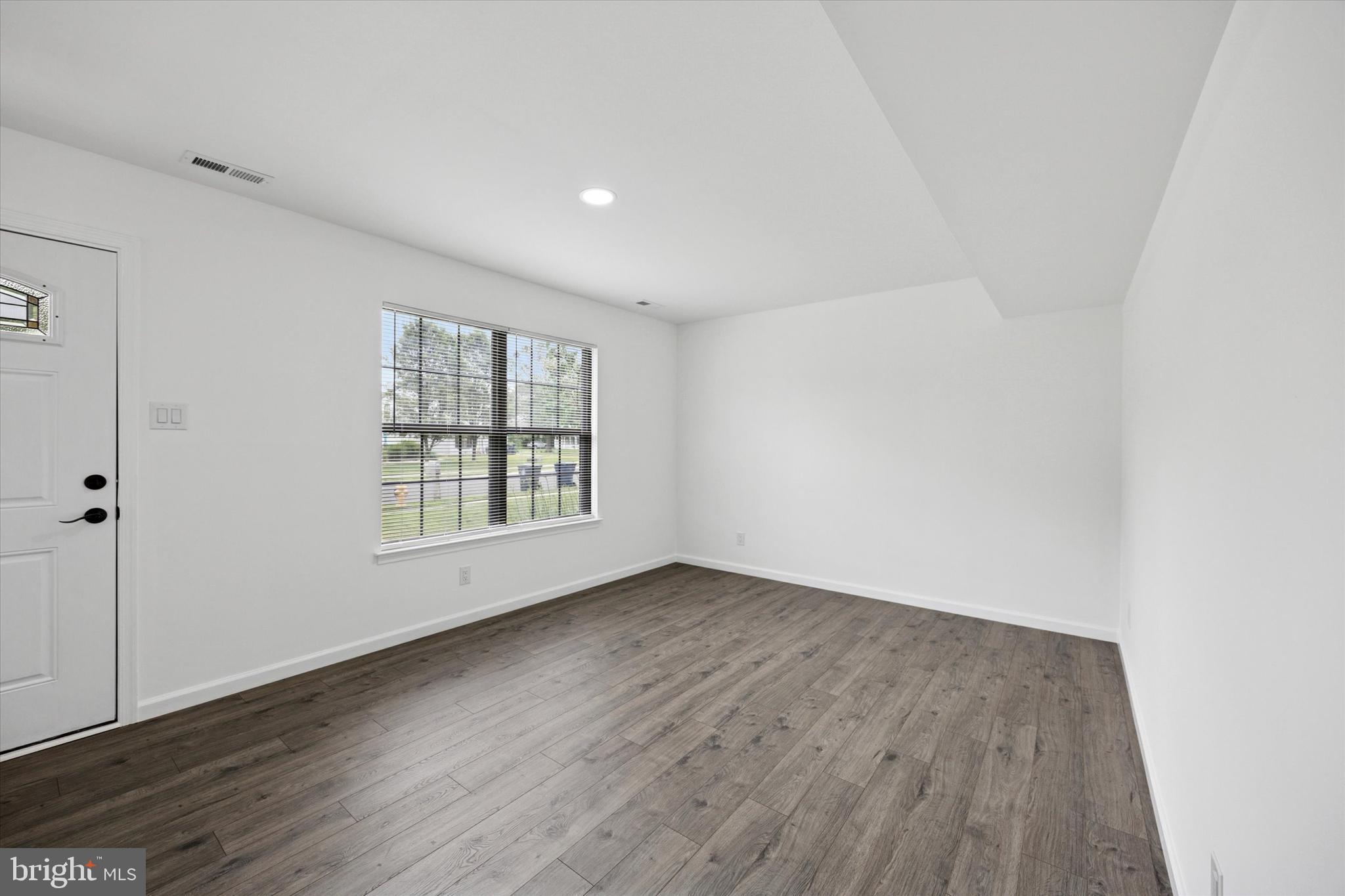 532 Cormorant Drive Voorhees, NJ 08043 - Photo 4 of 25 an empty room with wooden floor and windows