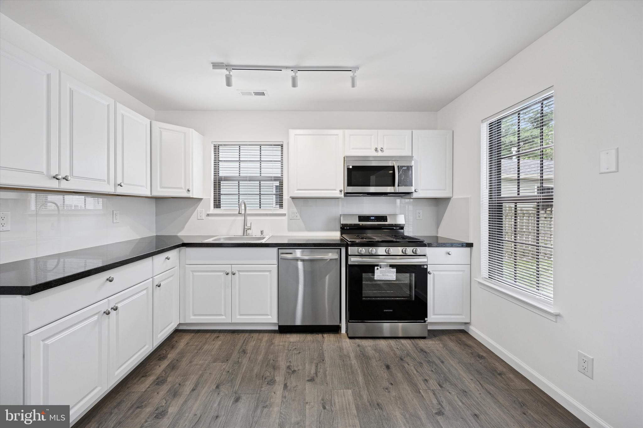 532 Cormorant Drive Voorhees, NJ 08043 - Photo 10 of 25 a kitchen with granite countertop white cabinets and stainless steel appliances