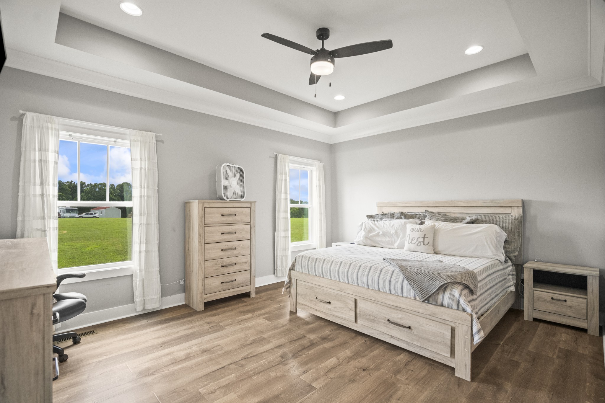 1406 Fowler Ford Road Portland, TN 37148 - Photo 36 of 54 a spacious bedroom with a large bed a chandelier and a window