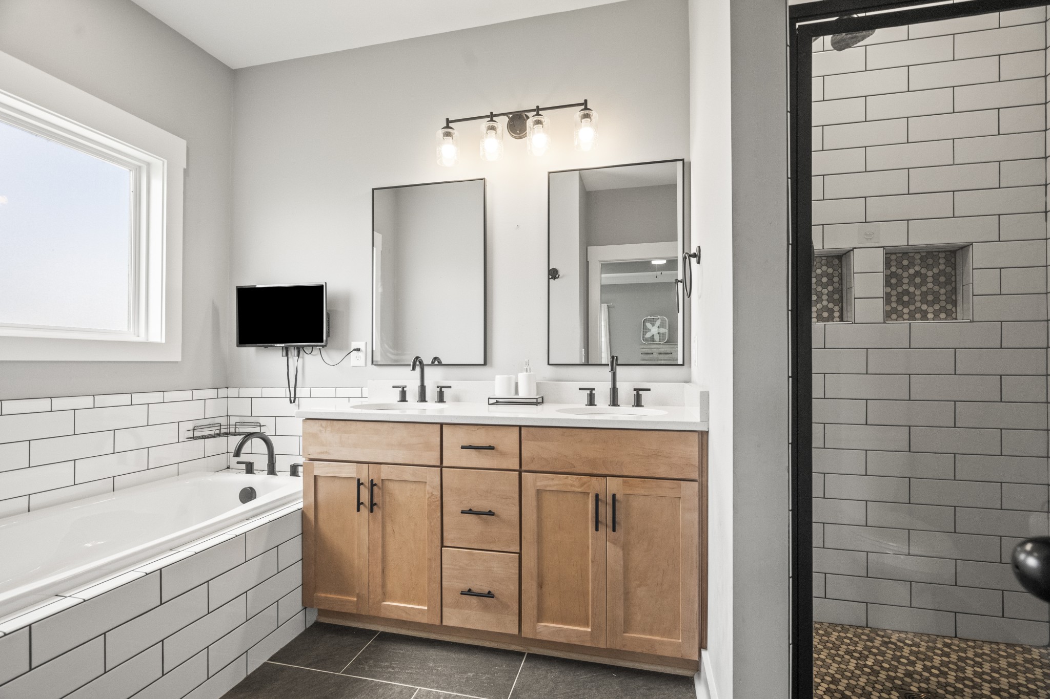1406 Fowler Ford Road Portland, TN 37148 - Photo 39 of 54 a bathroom with a double vanity sink a mirror and a bathtub