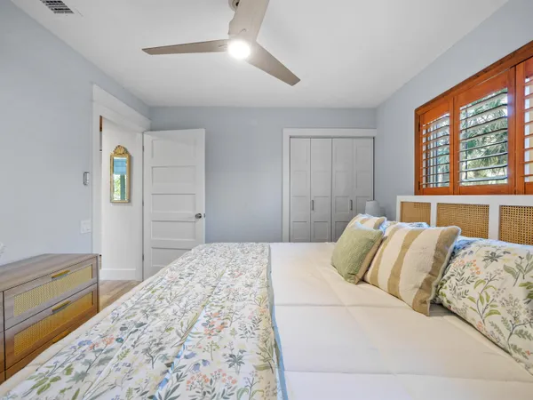 a bedroom with a large bed and a dresser