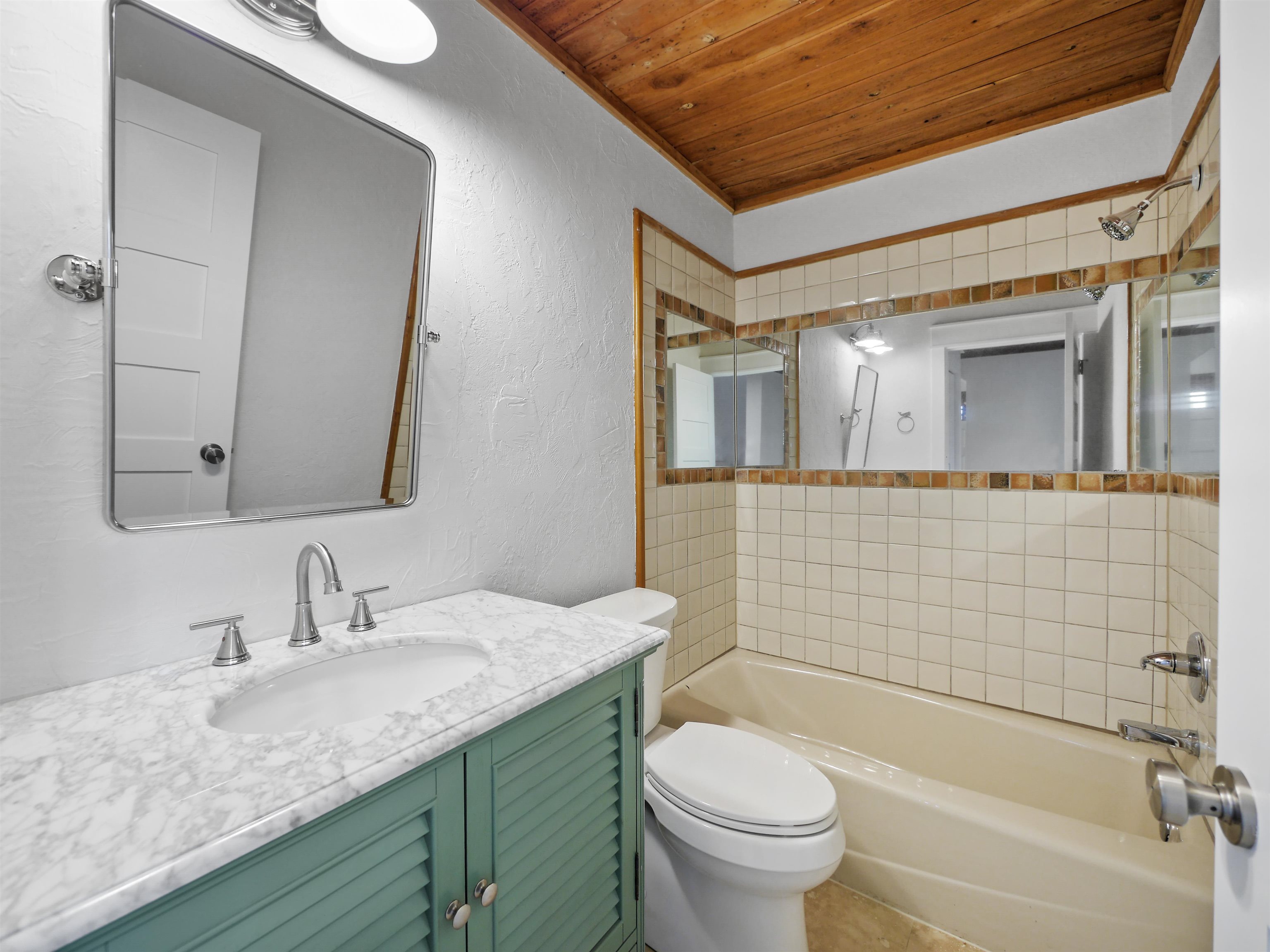 5372 Atlantic View St. Augustine, FL 32080 - Photo 13 of 56 a bathroom with a granite countertop sink toilet and shower