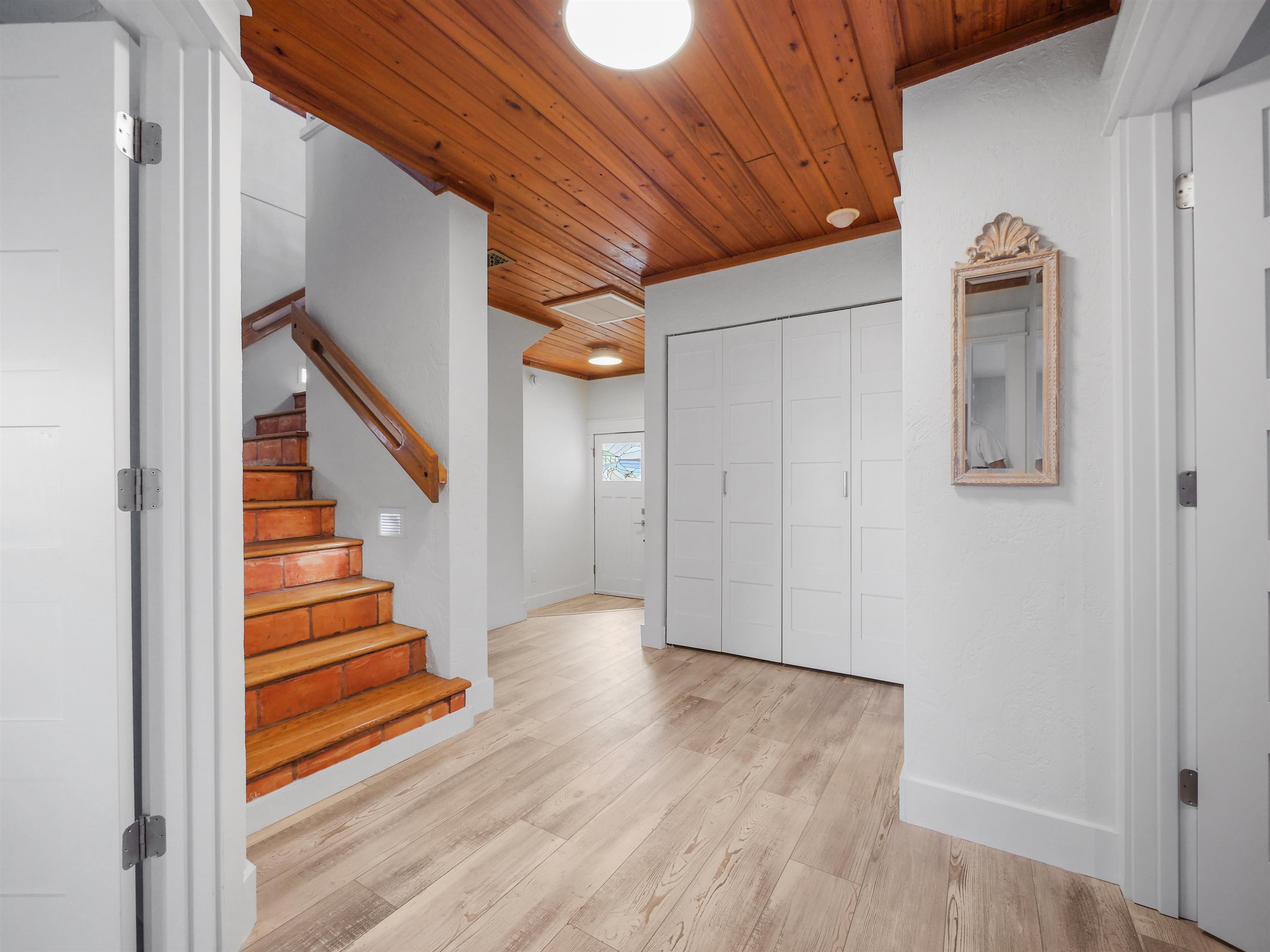 5372 Atlantic View St. Augustine, FL 32080 - Photo 18 of 56 a view of a hallway with wooden floor and staircase