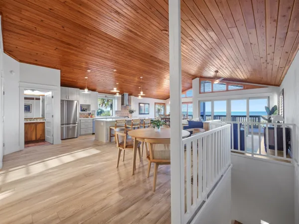 a dining room with furniture and wooden floor