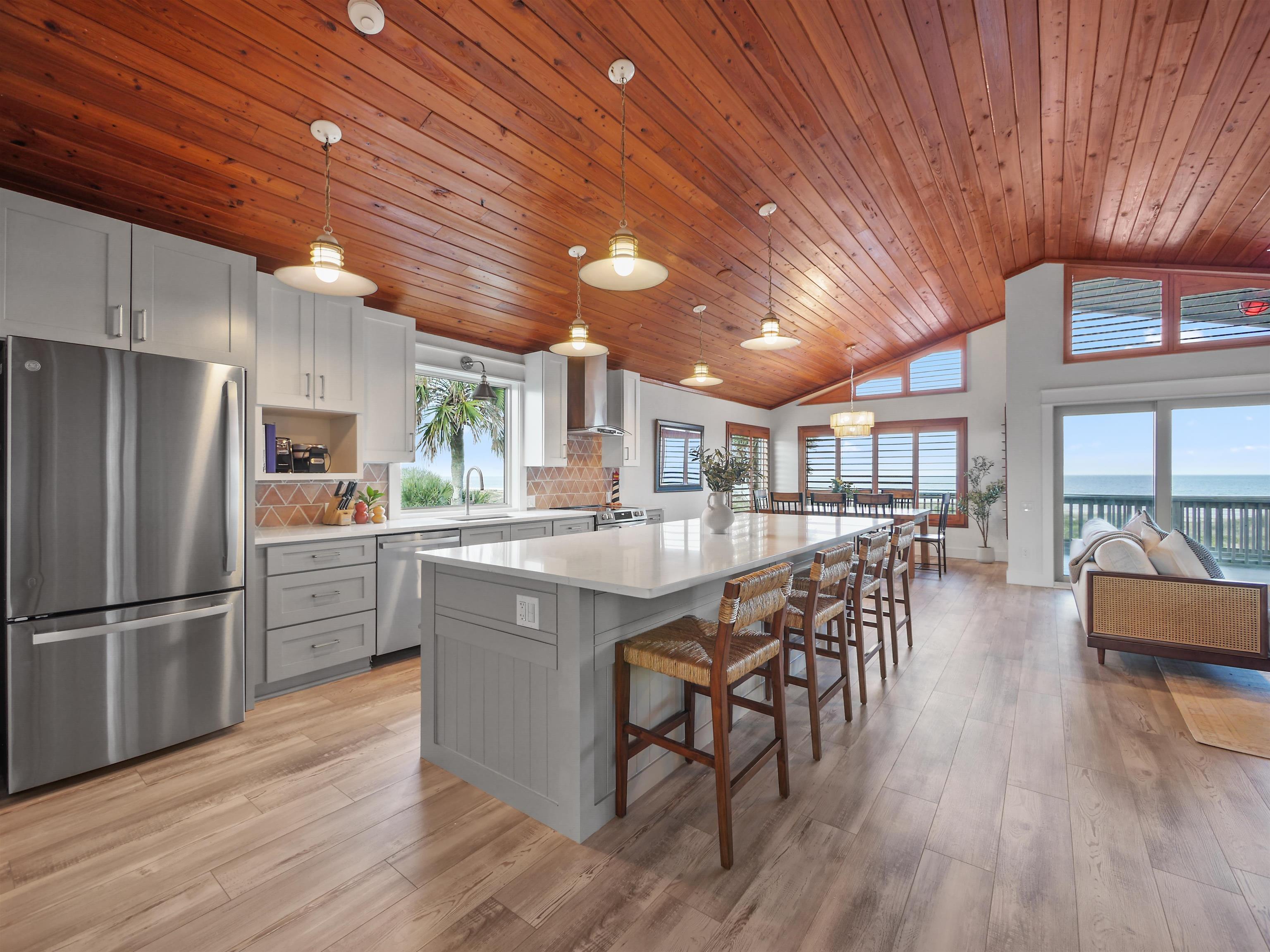5372 Atlantic View St. Augustine, FL 32080 - Photo 24 of 56 a kitchen with stainless steel appliances granite countertop a table chairs stove and wooden floor