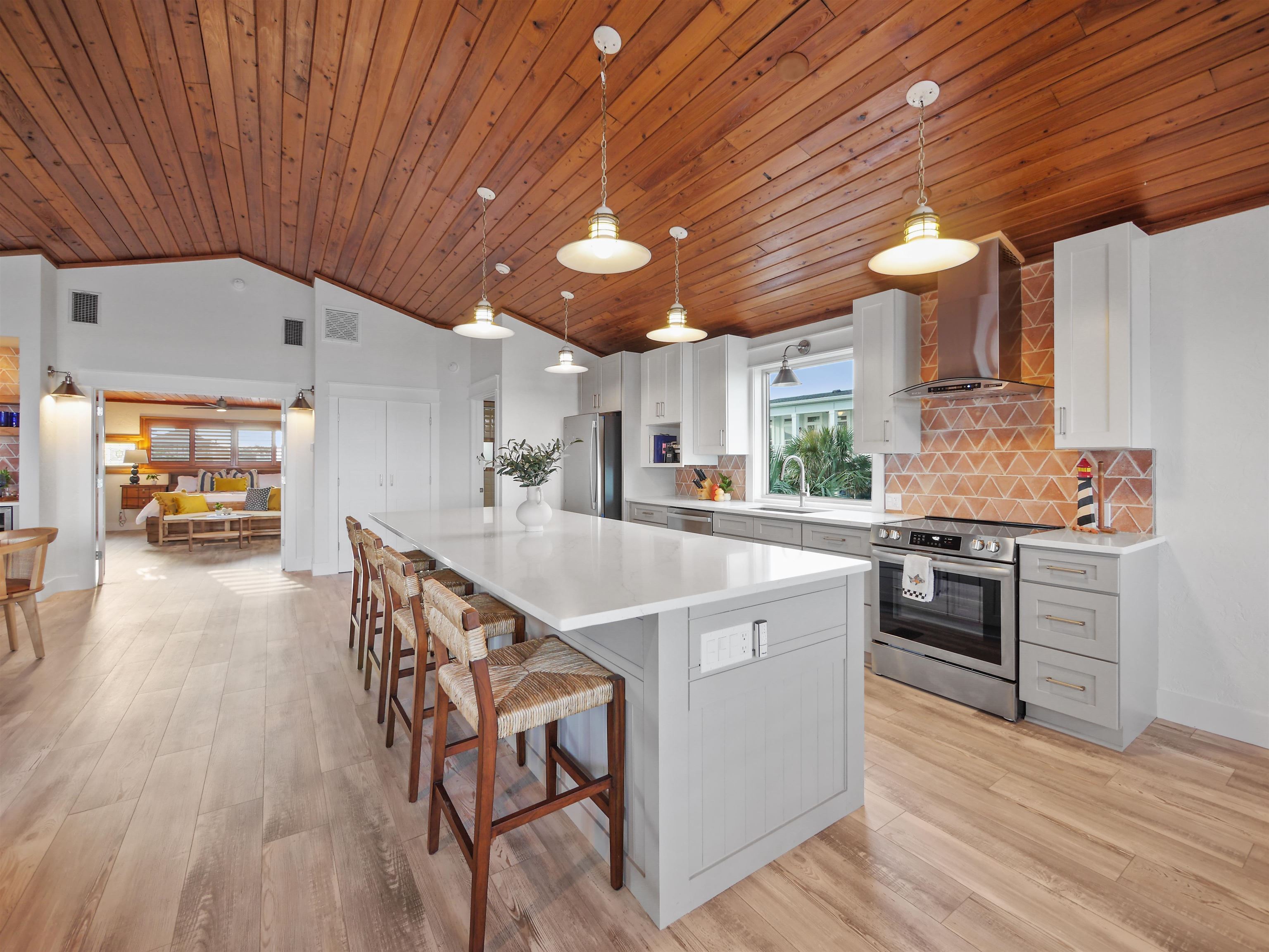 5372 Atlantic View St. Augustine, FL 32080 - Photo 27 of 56 a kitchen with stainless steel appliances granite countertop a stove a sink dishwasher and a refrigerator with wooden floor