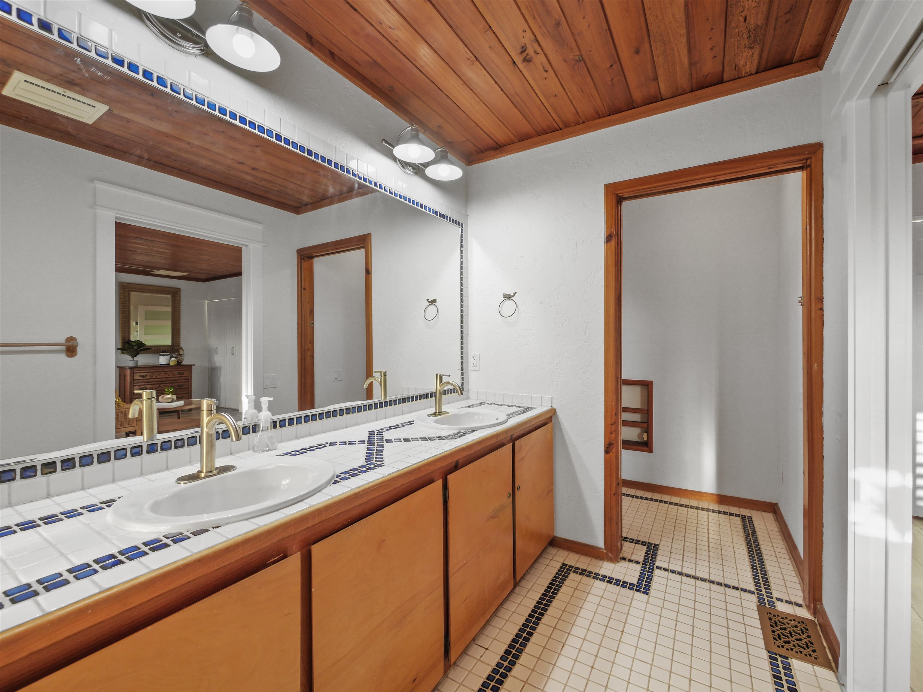 5372 Atlantic View St. Augustine, FL 32080 - Photo 35 of 56 a bathroom with a sink and a mirror