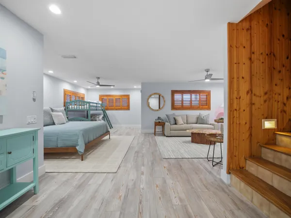 a spacious bedroom with two beds and a large mirror