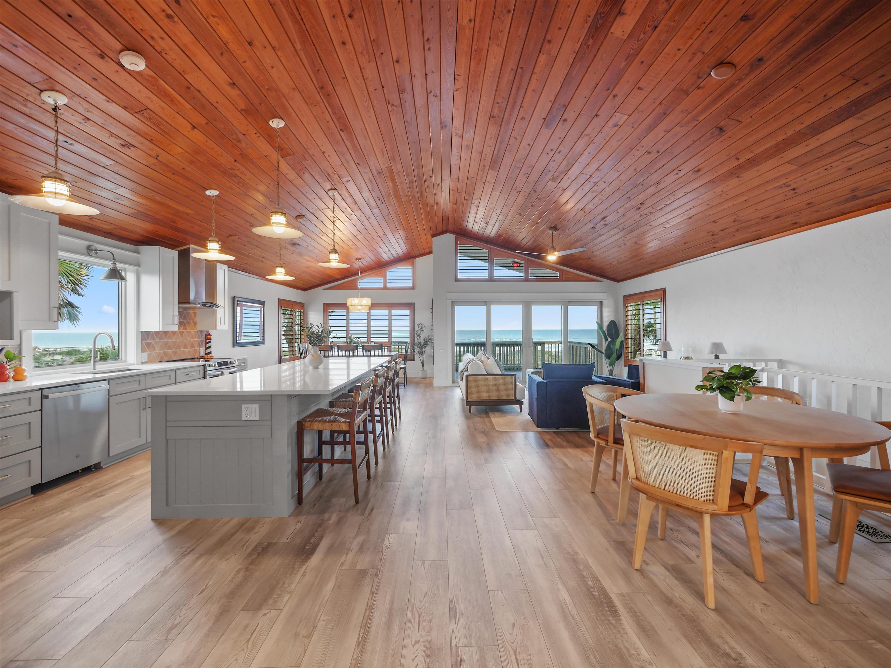 5372 Atlantic View St. Augustine, FL 32080 - Photo 4 of 56 a open kitchen with stainless steel appliances granite countertop a table chairs stove and wooden floor