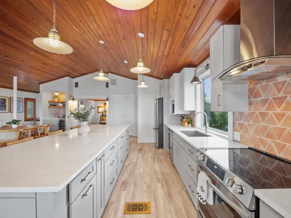 a large kitchen with stainless steel appliances granite countertop a lot of counter space