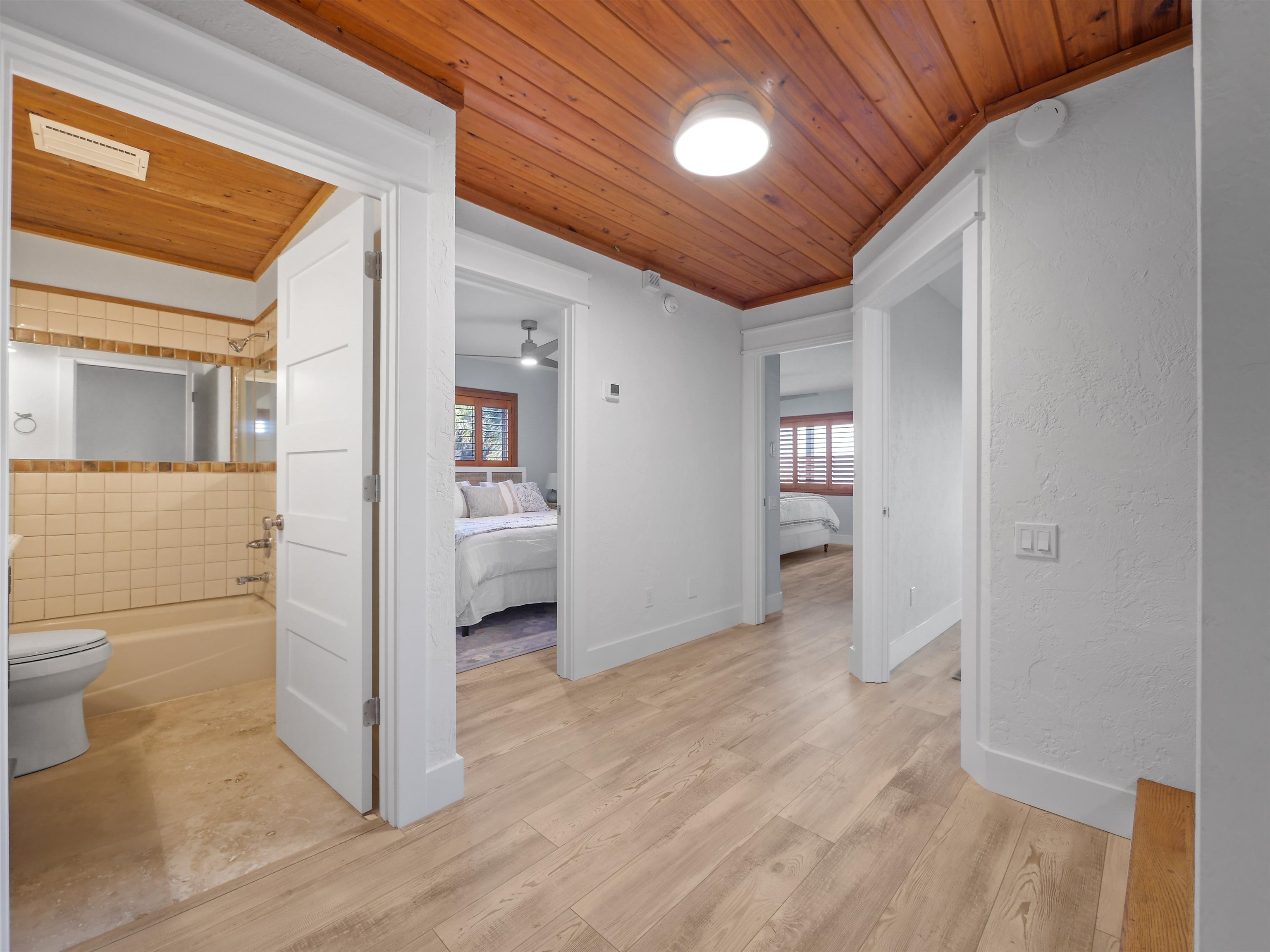 5372 Atlantic View St. Augustine, FL 32080 - Photo 10 of 56 a view of a hallway with wooden floor and a bathroom