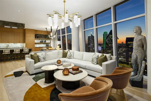 a living room with furniture a lamp and a chandelier