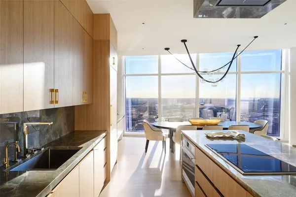 a kitchen with a large window and cabinets