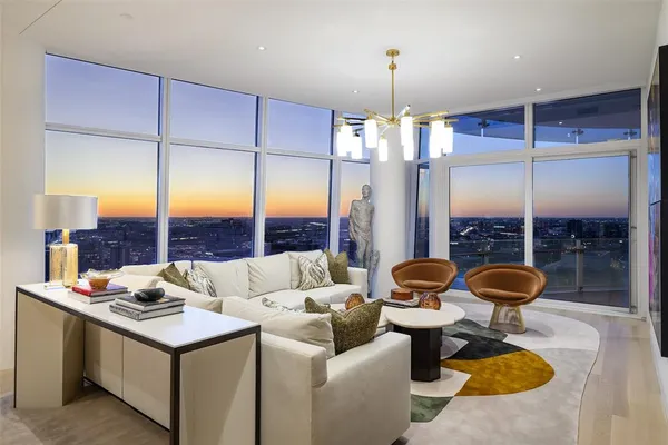 a living room with furniture and a floor to ceiling window