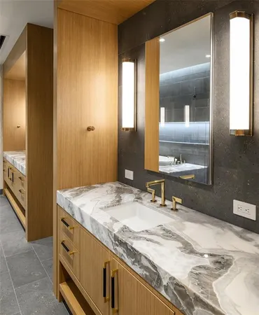 a bathroom with a granite countertop sink and a mirror
