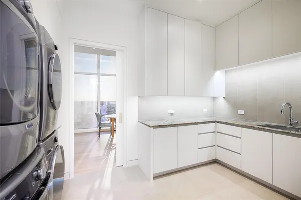 a kitchen with a sink appliances and cabinets