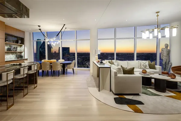 a living room with lots of furniture and painting on the wall