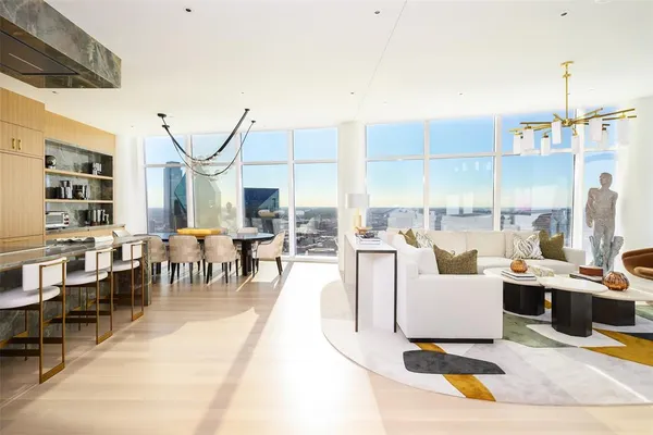 a living room with lots of furniture and a chandelier