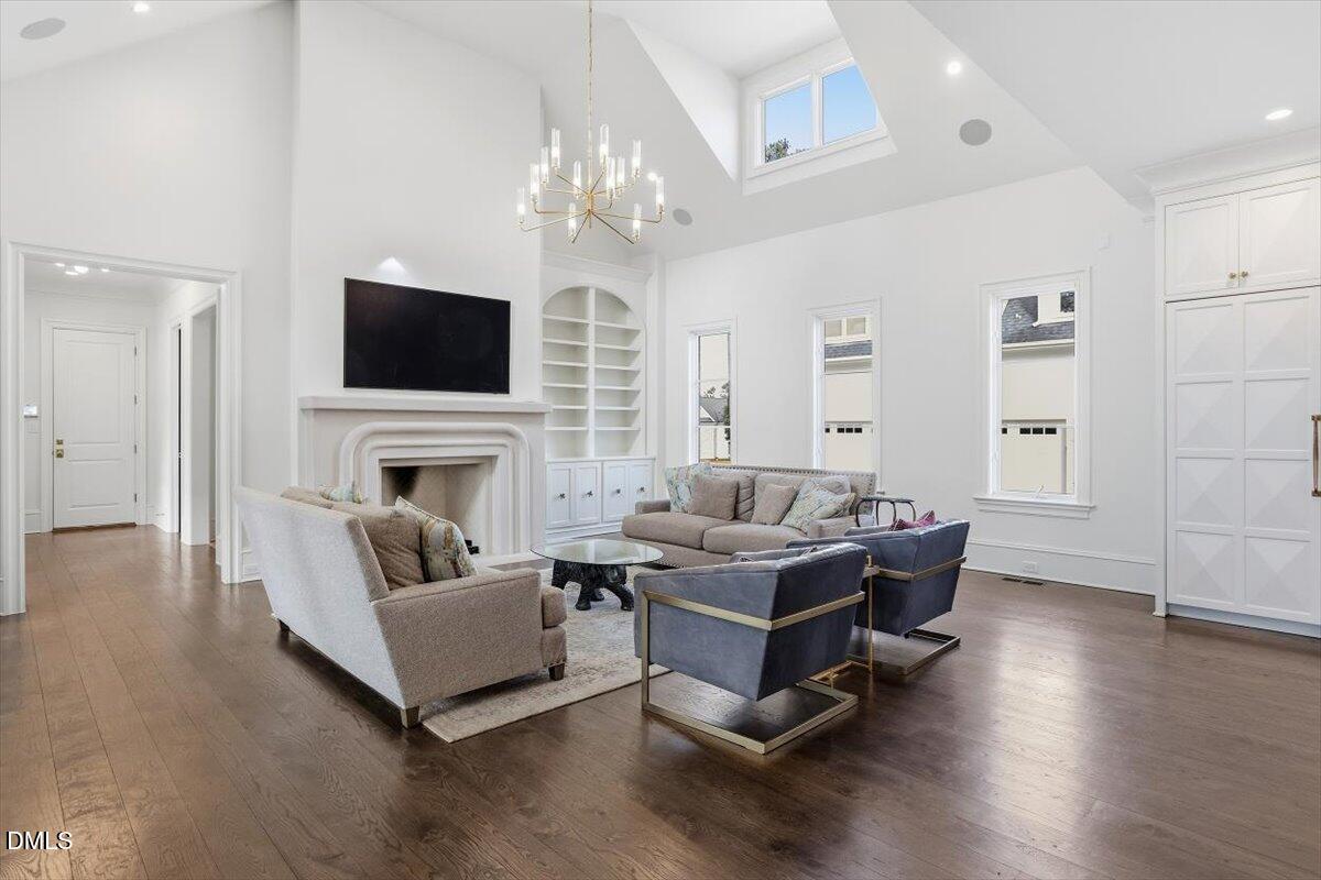 2123 St Marys Street Raleigh, NC 27608 - Photo 17 of 77 a living room with fireplace furniture and a flat screen tv