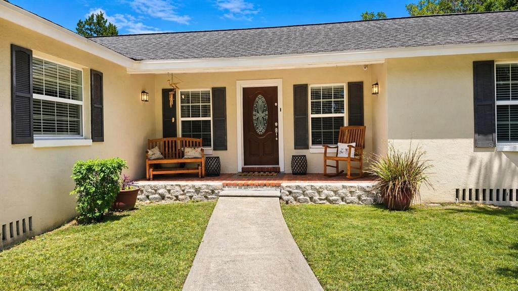 2313 Southeast 7th Street Ocala, FL 34471 - Photo 4 of 54 a front view of a house with a yard