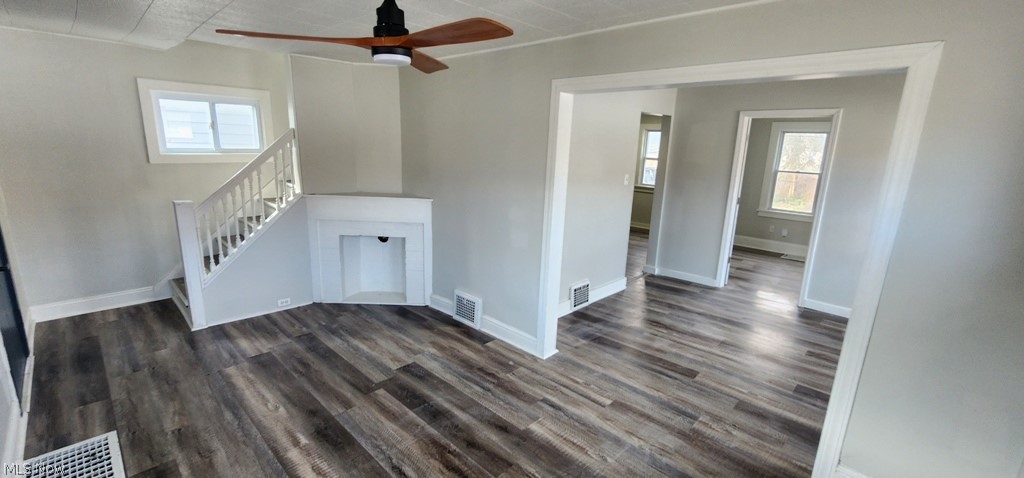 1514 Clermont Road Cleveland, OH 44110 - Photo 2 of 16 Unfurnished living room with a ceiling fan and dark wood finished floors
